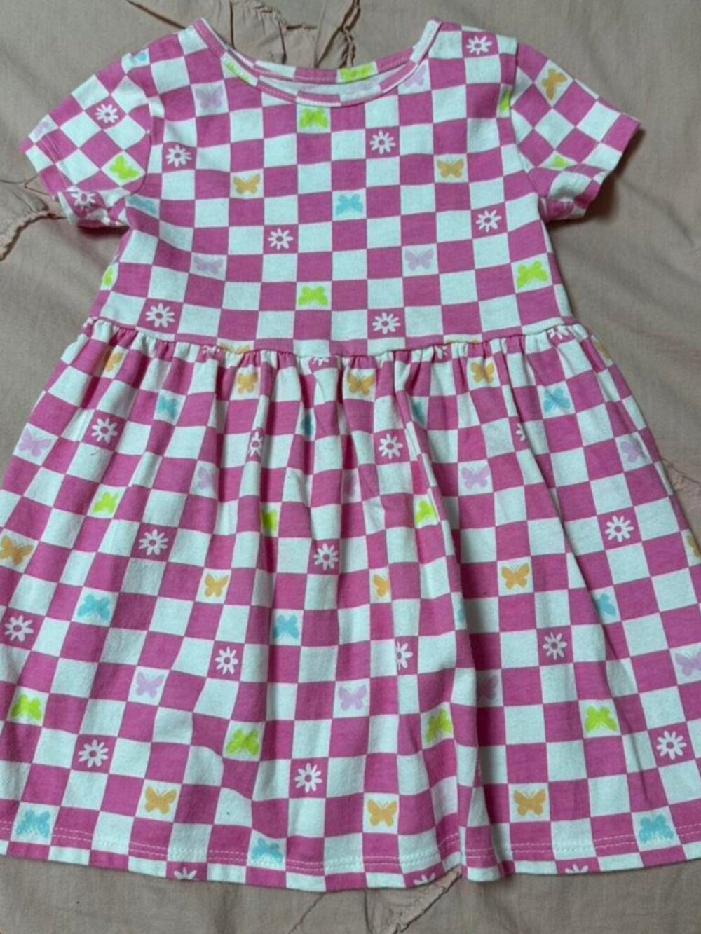 Pink and white checkered baby dress with butterfly & flower details.